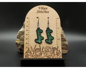 Machine embroidered earrings of the word Lucky in green with black border. Black hypoallergenic hooks.